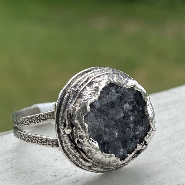 Oh!  The sparkle these bits of crystal make as your hand moves.  The trendy, large ring features a textured Sterling Silver split ring band and a layered freeform Sterling Silver bezel.  Almost 17mm around and 7mm deep this is a standout ring!  Size 8.5