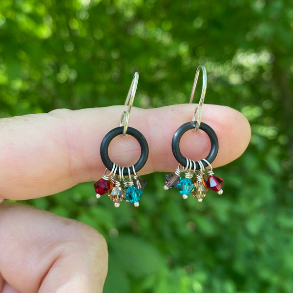 Did you know the Chakra colors are the same as the Pride colors which are the same as Rainbow colors?    Six Swarovski™ crystals (one for each color of the rainbow) dangle from repurposed black rubber washers and 20 gauge Argentium™ ear wires.  Washer 7/16" round  4mm Swarovski™   Charm Length: .75"  Charm Width:  .75" at widest part  Total length including ear wires:  1.25"