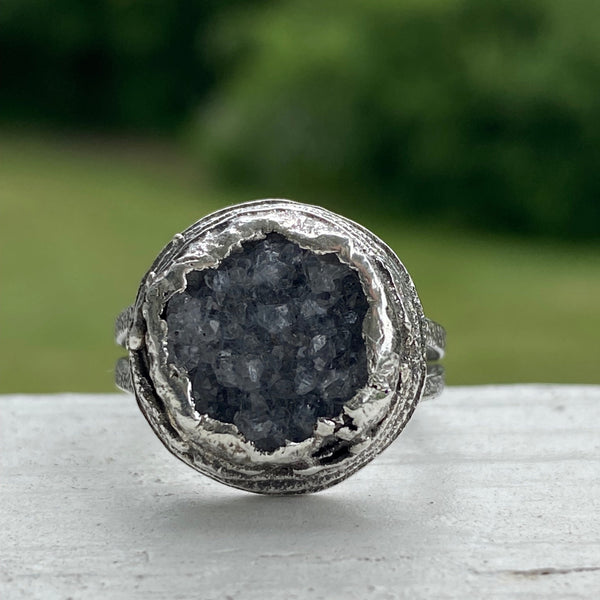Oh!  The sparkle these bits of crystal make as your hand moves.  The trendy, large ring features a textured Sterling Silver split ring band and a layered freeform Sterling Silver bezel.  Almost 17mm around and 7mm deep this is a standout ring!  Size 8.5