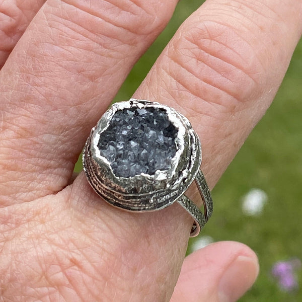 Oh!  The sparkle these bits of crystal make as your hand moves.  The trendy, large ring features a textured Sterling Silver split ring band and a layered freeform Sterling Silver bezel.  Almost 17mm around and 7mm deep this is a standout ring!  Size 8.5