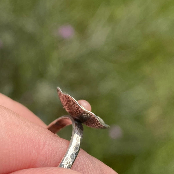 Textured and patinated Sterling Silver and a 3mm Peach Moonstone combine to create a delicate flower ring.  Peach Moonstone...such a powerful stone with much to offer.  A stone for wishing and hoping, it recognizes the difference between need and want on a universal level.  Size 7.75