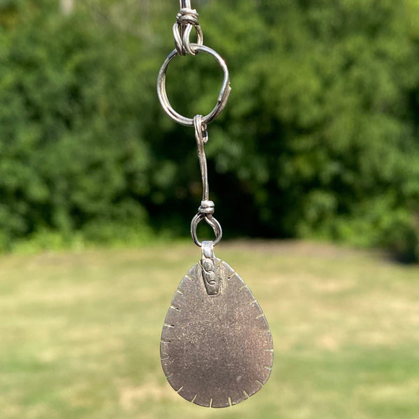 Light blue with brown markings this pear shaped Hubei Turquoise measures 20 x 13mm.  It is set in Sterling Silver and surrounded with oval beads.  Charm:  1.25L x .75(ish)W  Chain:  18" patterned, oxidized 6.4mm cable chain with Lobster clasp.  The addition of handmade embellishments make the chain 22" in length.