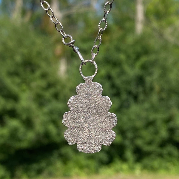 Blue and green are the predominant colors of this beautiful teardrop shaped Hubei Turquoise stone.  Measuring 17 x 11mm it is set in texturized layers of Sterling Sterling Silver.  Charm:  1.25L x .75W  Chain: 20" oxidized, patterned 2.8mm cable chain and handmade hook clasp.