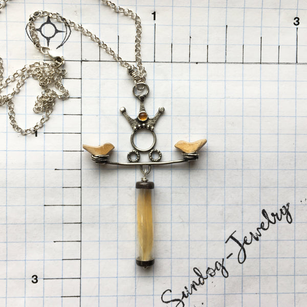 “When the Sun of compassion arises...the singing birds come from nowhere.”  ― Amit Ray  A tiny, found yellow feather, birds made from vintage rulers and a Goddess reaching her hands to hold them with love.  The 3mm Citrine is said to harness the energy of the sun and brings light to all areas of life.  Textured and patinated Sterling Silver and Argentium™.  Chain:  16"L, Sterling Silver Rolo Chain, Lobster Clasp  Charm:  2 1/2"L x 1 3/4"W