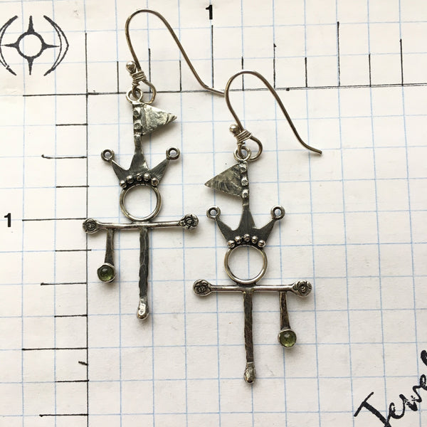 Let the world know you are flying your Flag of Peace and Summer Spirit while wearing the Sterling Silver and Argentium™ earrings.  A stone of compassion, the 3mm Peridot offers many gifts.  The bright, inviting green stone can inspire creativity and delight along with calm and safety.  Total length with ear wire:  2 1/2" long  Charm Size:  1 3/4"L x 15/16"W