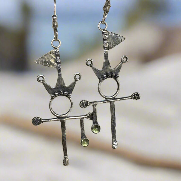 Let the world know you are flying your Flag of Peace and Summer Spirit while wearing the Sterling Silver and Argentium™ earrings.  A stone of compassion, the 3mm Peridot offers many gifts.  The bright, inviting green stone can inspire creativity and delight along with calm and safety.  Total length with ear wire:  2 1/2" long  Charm Size:  1 3/4"L x 15/16"W