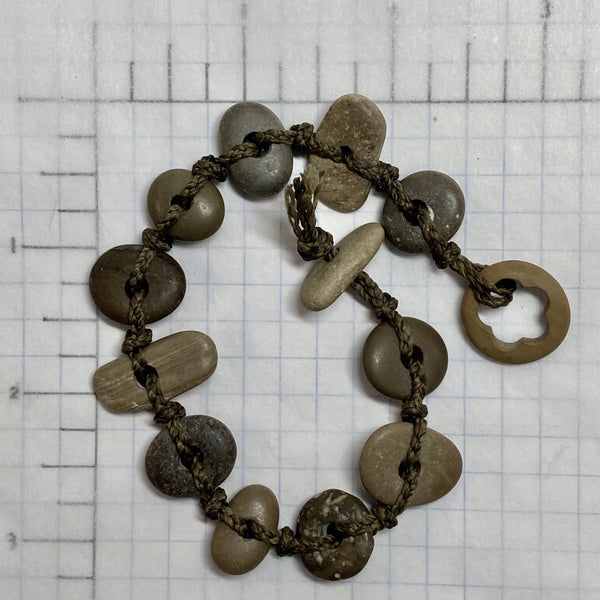 A day at the beach...The smell of suntan lotion.  The warmth of the sun on our skin.  The sounds of waves crashing and children laughing.  Bliss.  Made with hand drilled Lake Michigan beach stones in red-brown colors and khaki colored braided waxed cotton cord.  The toggle clasp is created from beach stones.  Total length- 8 1/2"  Fits up to 7 3/4" wrist