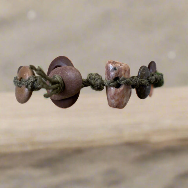 A day at the beach...The smell of suntan lotion.  The warmth of the sun on our skin.  The sounds of waves crashing and children laughing.  Bliss.  Made with hand drilled Lake Michigan beach stones in red-brown colors and khaki colored braided waxed linen cord, wear these bracelets to remind you of all things summer.  The toggle clasp is created from beach stones.  Total length- 8 1/2"  Fits up to 7 3/4" wrist