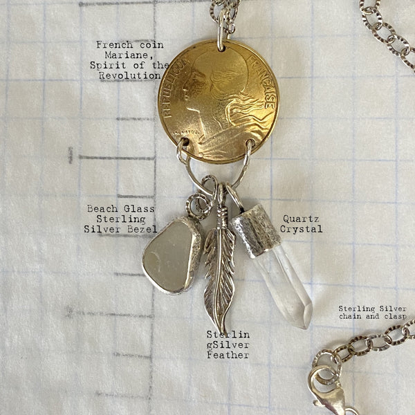 Need to start an Evolution Revolution?   Let Marianne, Spirit of the Revolution, ride with you! The vintage French brass coin features the words liberte, egalite and fraternite...liberty, equality, fraternity. She also carries a few charms...a Sterling Silver feather for flight/freedom, Quartz Crystal (known as a master healer) and a bit of beach glass set in Sterling Silver with a heart cut into it.
Charm: 2" long x 3/4" wide
Chain: 18" textured and patinated 2.8mm Sterling