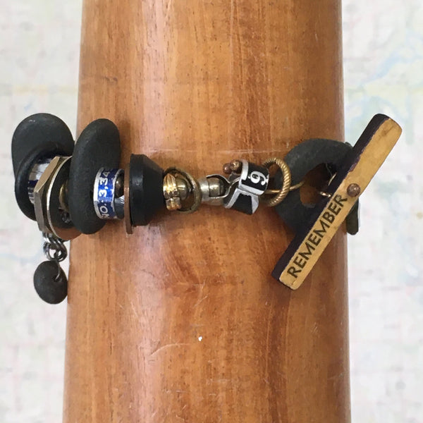 What is it you need to remember?  A birthday?  Why you walked into the kitchen?   This whimsical bracelet uses a vintage ruler and beach stone to create the unique toggle clasp.  Other random miscellany (bits of sewing rulers and hardware store parts) symbolize all the "bits" floating in our heads.  Fancy Jasper stars can remind us to be kind to our forgetful selves!  Sterling Silver double Curb chain.  Size:  8" long x 1 1/2" at the widest part