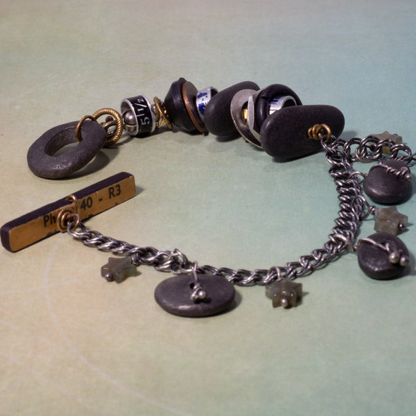 What is it you need to remember?  A birthday?  Why you walked into the kitchen?  This whimsical bracelet uses a vintage ruler and beach stone to create the unique toggle clasp.  Other random miscellany (bits of sewing rulers and hardware store parts) symbolize all the "bits" floating in our heads.  Fancy Jasper stars can remind us to be kind to our forgetful selves!