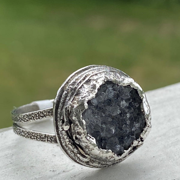  Oh!  The sparkle these bits of crystal make as your hand moves.  The trendy, large ring features a textured Sterling Silver split ring band and a layered freeform Sterling Silver bezel.  Almost 17mm around and 7mm deep this is a standout ring!  Size 8.5