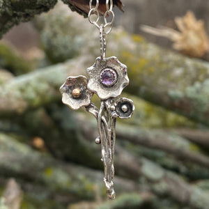 As it snows in April I reach for calmness and wisdom while waiting for spring to arrive.    The 3mm Amethyst cabochon offers calm as the flowers slowly spring to life around it.  A bouquet of hope that spring is just around the corner.  (In Wisconsin that corner might be a couple miles away!)  Also known for clarity and encouraging sobriety,  Amethyst invites the third eye to open and is connected to the crown chakra.