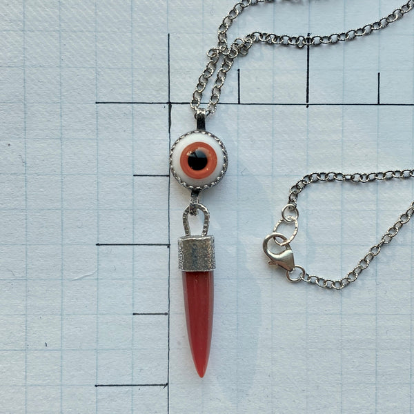 "Since one is love, there is nothing to do but offer love-each offer of love bringing an exponential increase in the quantity of love returned" Melody (Love is in the Earth).

An orange Carnelian point dangles from an orange, 10mm glass "eye". Both are set in textured and oxidized bezels.

Wearing this talisman can open your eyes to your ability to give and receive love of all varieties.

Charm: 2" long x 1/2" wide

Chain: 16" Sterling Silver 2mm patterned and oxidized cable chain with lobster clasp