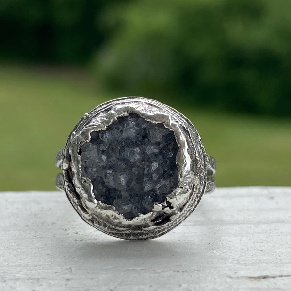  Oh!  The sparkle these bits of crystal make as your hand moves.  The trendy, large ring features a textured Sterling Silver split ring band and a layered freeform Sterling Silver bezel.  Almost 17mm around and 7mm deep this is a standout ring!  Size 8.5