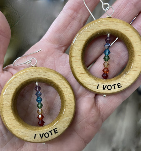 Use the power of your vote.  Shout it out loud!  I VOTE!  20 gauge Argentium™ Earwires  Total Length:  2 3/4"  Charm Size: 1 3/4" diameter  Found object/repurposed wood  Due to the nature of found objects, these earrings are part of a limited edition. 