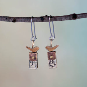 Perched atop a tiny book made from discarded hymnals, micro screws and Scrappy Treasures*, these handmade earrings feature tiny birds singing their songs of praise just for you!  