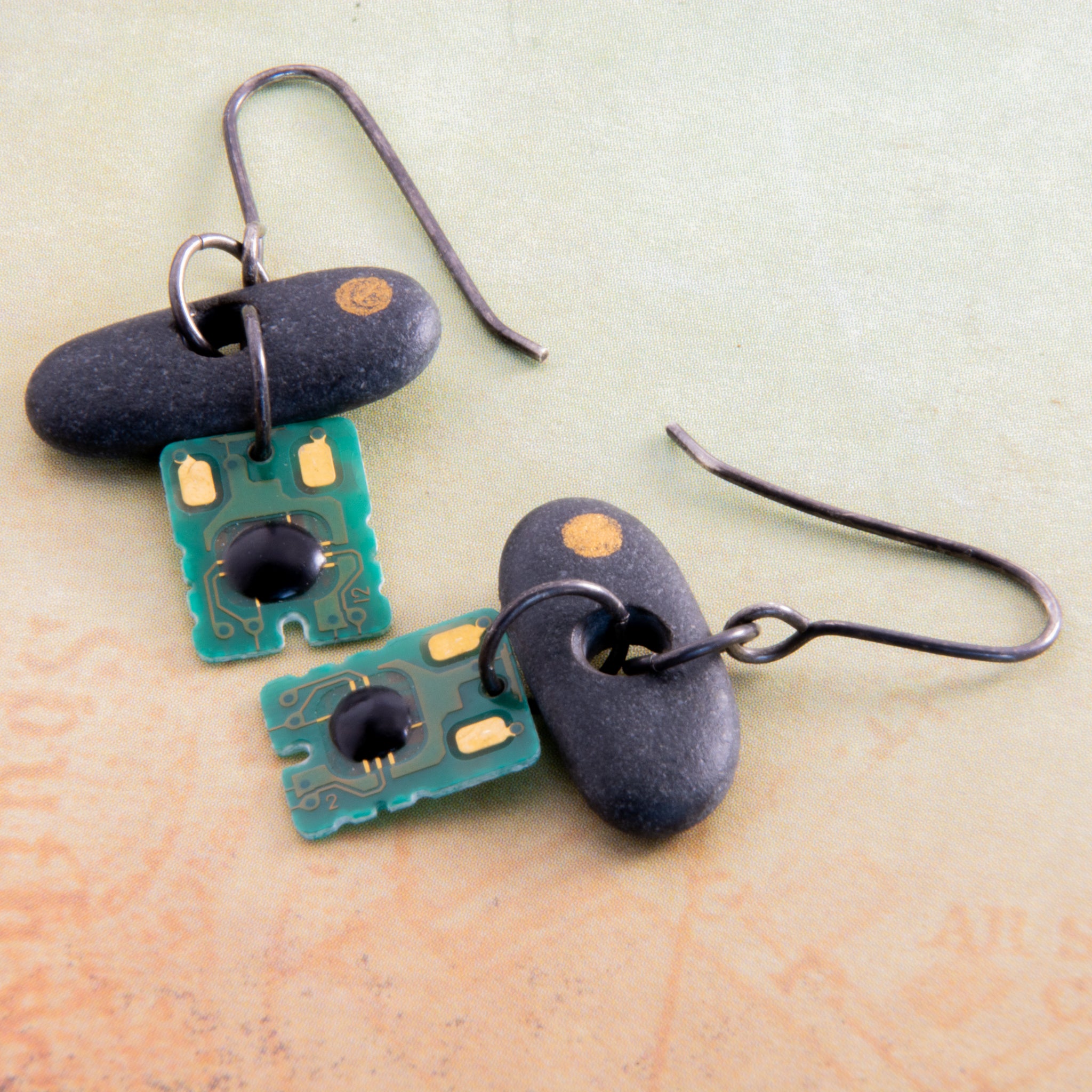 Is it nature or nurture or a combination of both that makes us who we are? This concept is explored in these mixed media purpose-filled earrings.  Edit alt text