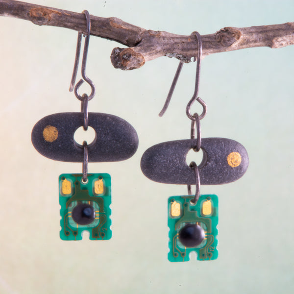 Is it nature or nurture or a combination of both that makes us who we are?  This concept is explored in these mixed media purpose-filled earrings.  
