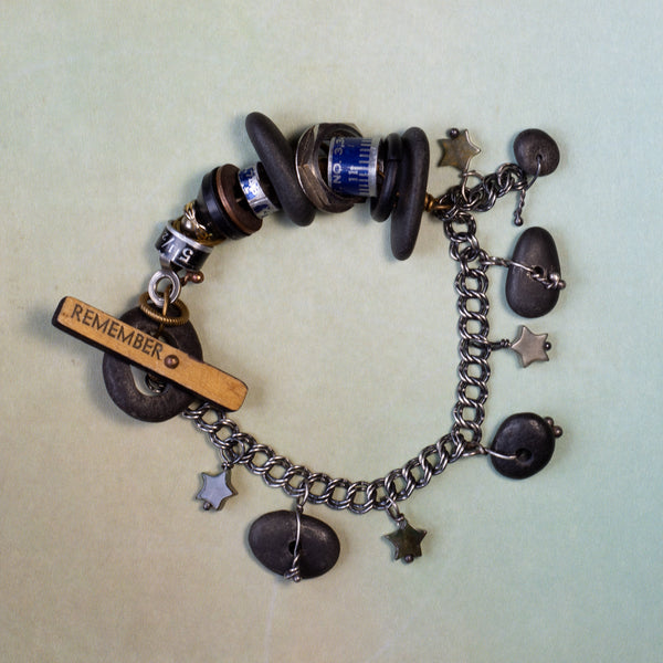 What is it you need to remember?  A birthday?  Why you walked into the kitchen?  This whimsical bracelet uses a vintage ruler and beach stone to create the unique toggle clasp.  Other random miscellany (bits of sewing rulers and hardware store parts) symbolize all the "bits" floating in our heads.  Fancy Jasper stars can remind us to be kind to our forgetful selves!